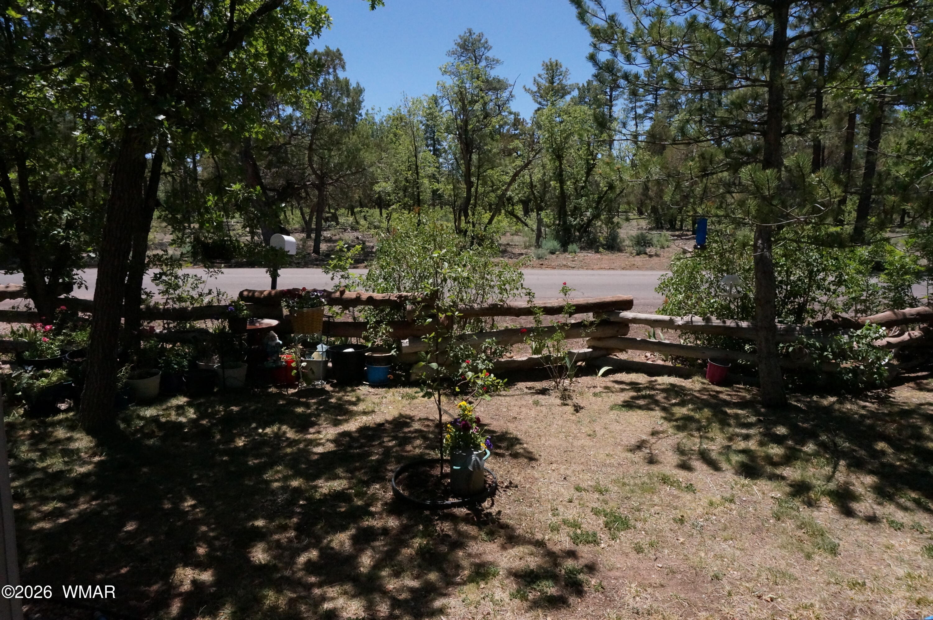 6066 Wagon Wheel Road Lakeside, AZ 85929 - Photo 29 of 32 a view of a green field covered with trees