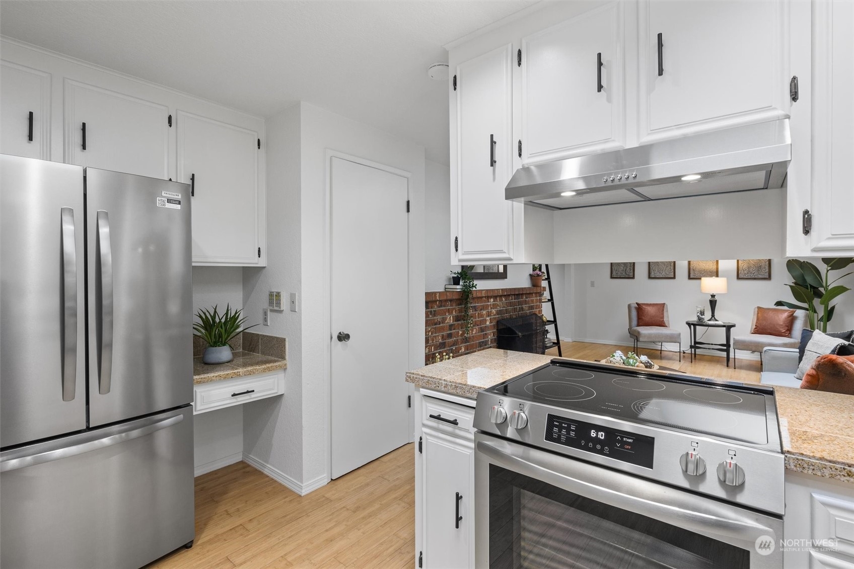 17631 7th Avenue West Bothell, WA 98012 - Photo 19 of 38 a kitchen with stainless steel appliances granite countertop a refrigerator a stove and a sink with wooden floor