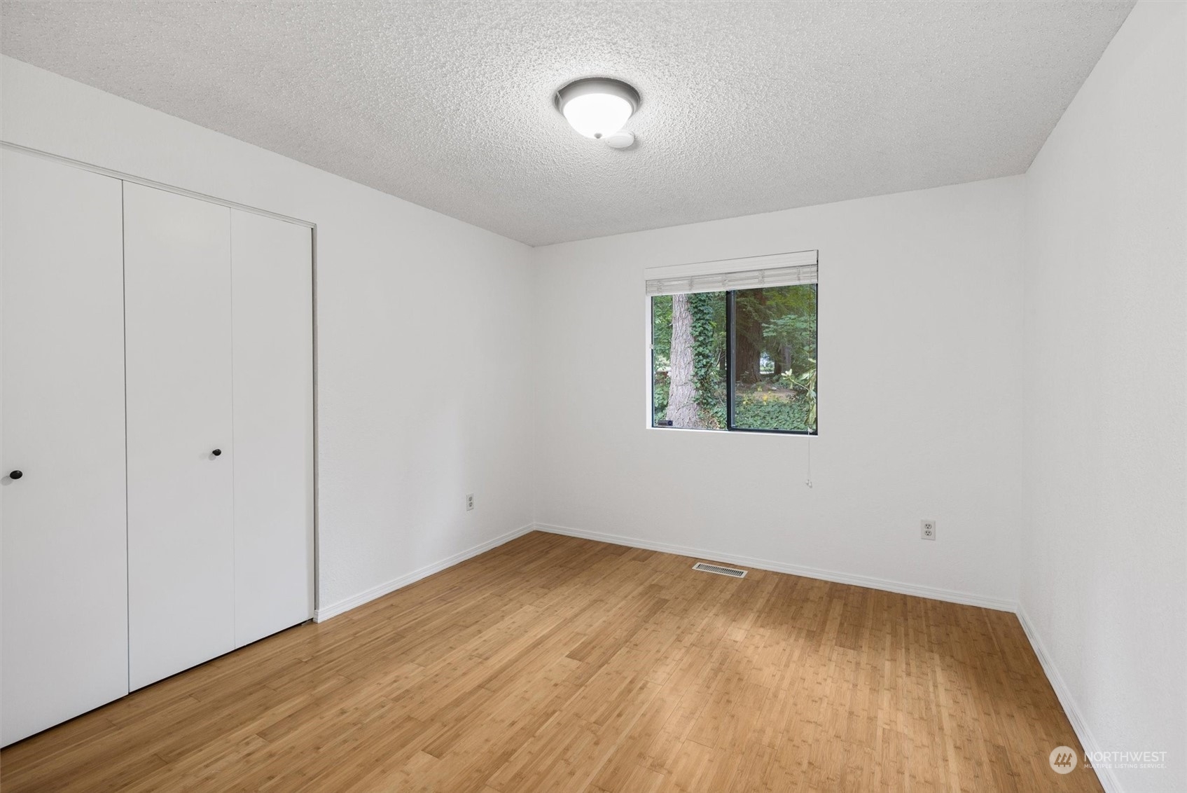 17631 7th Avenue West Bothell, WA 98012 - Photo 24 of 38 a view of an empty room with wooden floor and a window