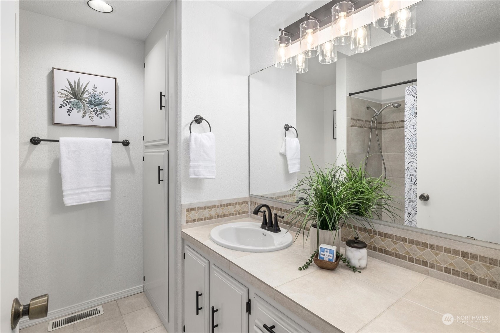 17631 7th Avenue West Bothell, WA 98012 - Photo 27 of 38 a bathroom with a sink a mirror and a shower