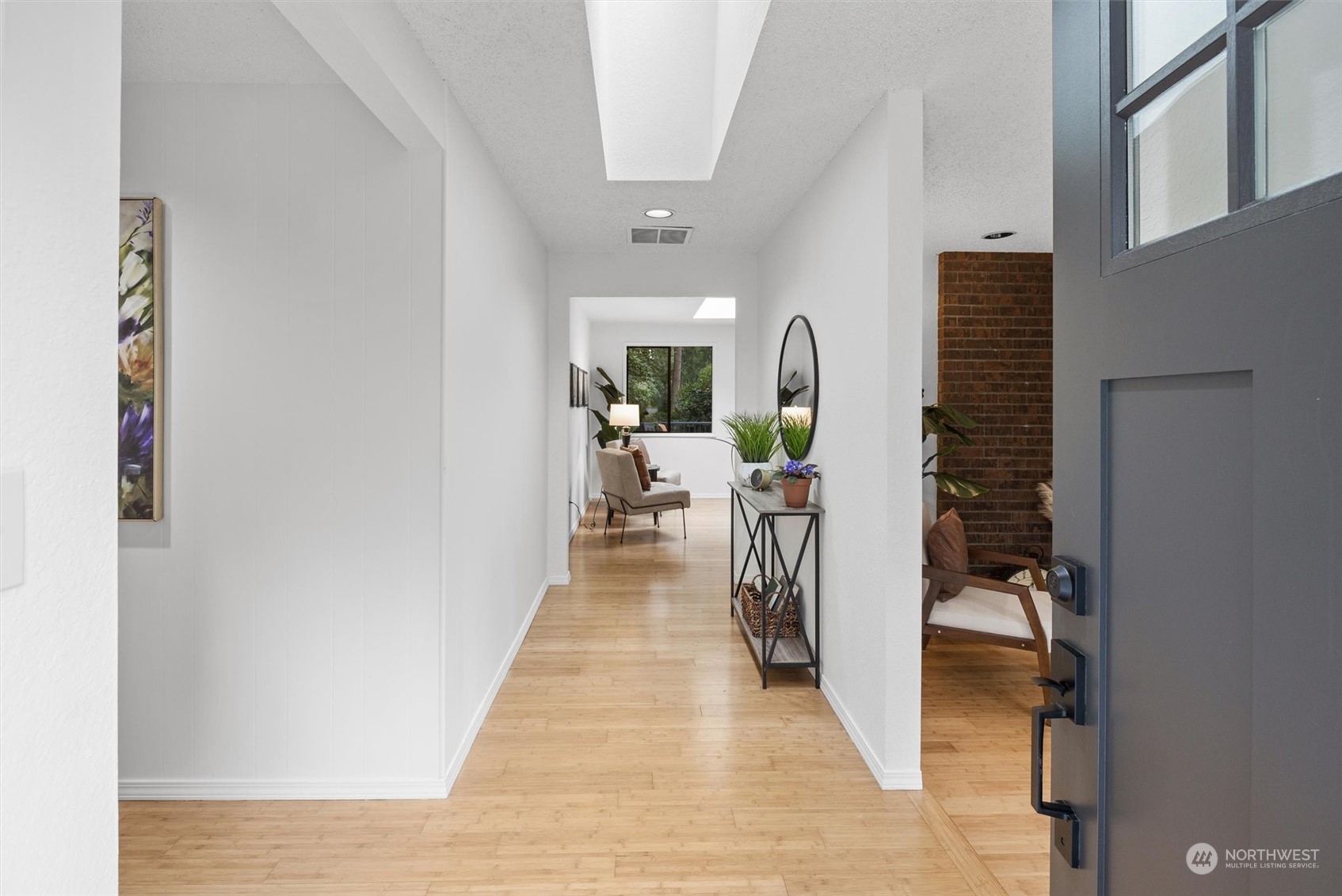 17631 7th Avenue West Bothell, WA 98012 - Photo 6 of 38 a hallway with a white cabinets and wooden floor