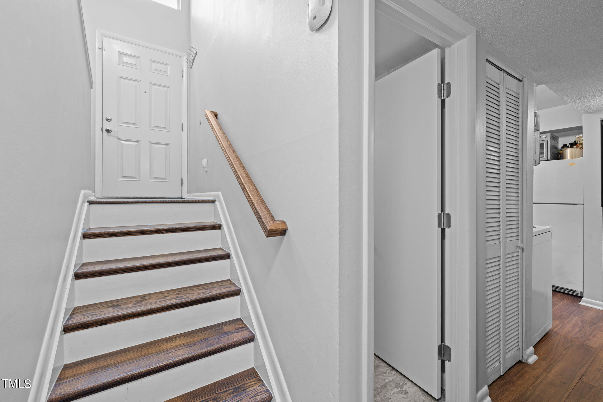 709 Godwin Court Raleigh, NC 27606 - Photo 14 of 31 a view of entryway with wooden floor and stairs