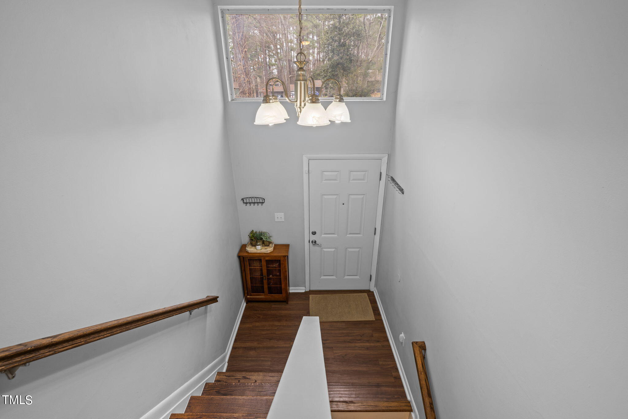 709 Godwin Court Raleigh, NC 27606 - Photo 16 of 31 a view of a hallway with wooden floor and a bathroom