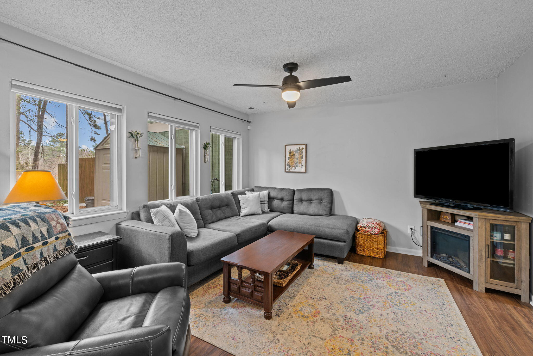 709 Godwin Court Raleigh, NC 27606 - Photo 7 of 31 a living room with furniture and a flat screen tv