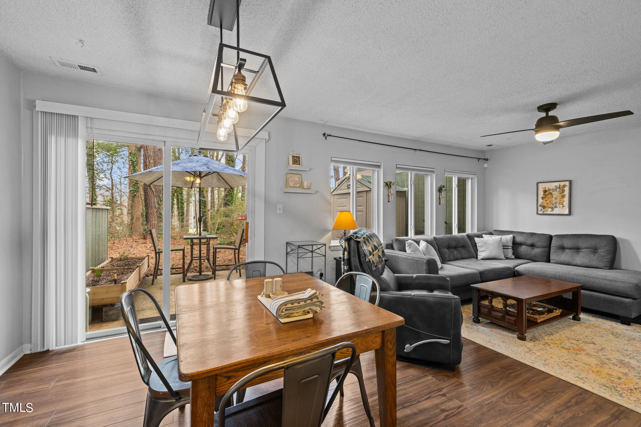 709 Godwin Court Raleigh, NC 27606 - Photo 9 of 31 a view of a dining room with furniture a chandelier and wooden floor