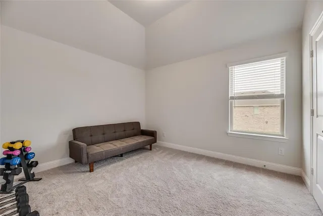 an empty room with furniture and a window