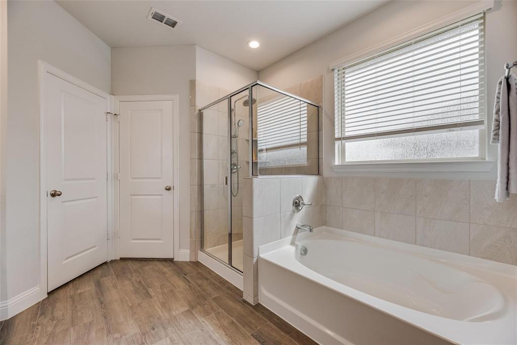 1271 Altuda Drive Forney, TX 75126 - Photo 21 of 35 a bathroom with a bathtub and a shower