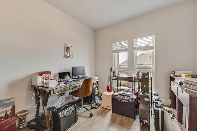 a view of a workspace with furniture and a window