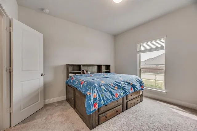 a bedroom with a bed and window