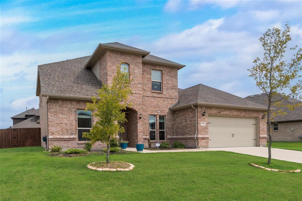 1271 Altuda Drive Forney, TX 75126 - Photo 4 of 35 a front view of a house with a garden and trees
