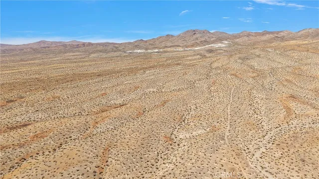 a view of a mountain range in a cloudy sky