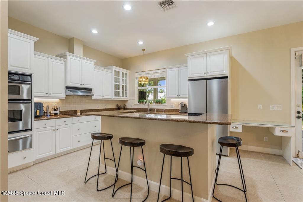 Undisclosed Address Vero Beach, FL 32966 - Photo 14 of 36 a kitchen with stainless steel appliances granite countertop a counter top space cabinets and a appliances