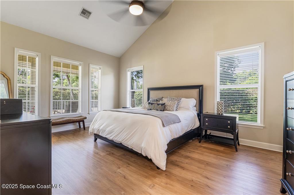 Undisclosed Address Vero Beach, FL 32966 - Photo 17 of 36 a bedroom with a bed wooden floor and lamp