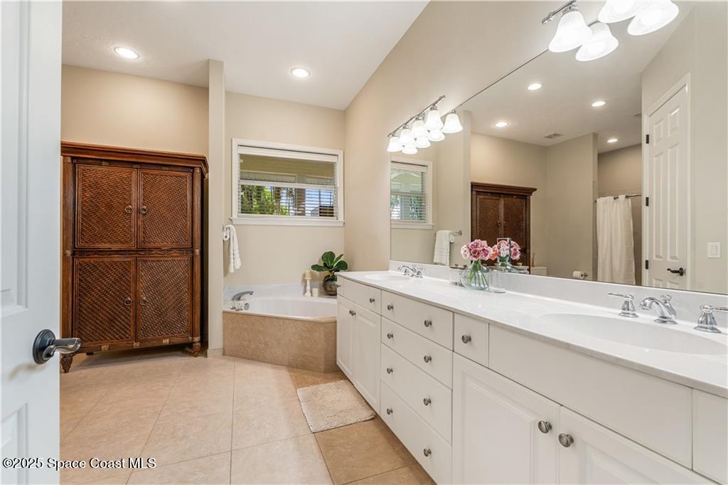 Undisclosed Address Vero Beach, FL 32966 - Photo 18 of 36 a bathroom with a tub sink and mirror
