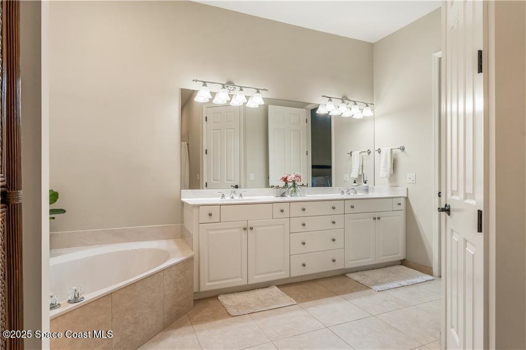 Undisclosed Address Vero Beach, FL 32966 - Photo 19 of 36 a bathroom with a double vanity sink mirror and bathtub
