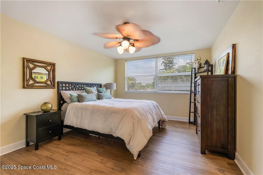 Undisclosed Address Vero Beach, FL 32966 - Photo 20 of 36 a bedroom with a bed and a chandelier