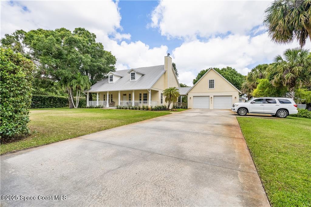 Undisclosed Address Vero Beach, FL 32966 - Photo 2 of 36 a front view of a house with garden
