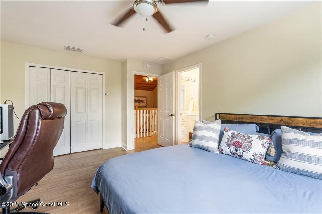 Undisclosed Address Vero Beach, FL 32966 - Photo 23 of 36 a bedroom with a bed closet and flowerpot