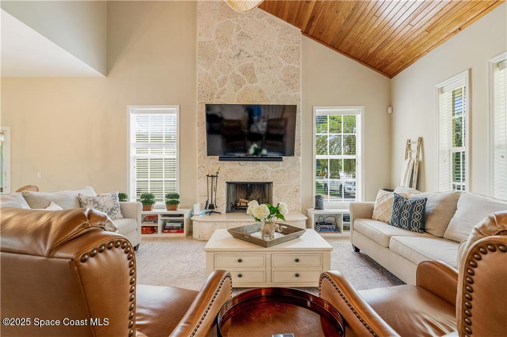 Undisclosed Address Vero Beach, FL 32966 - Photo 3 of 36 a living room with furniture a flat screen tv and a fireplace