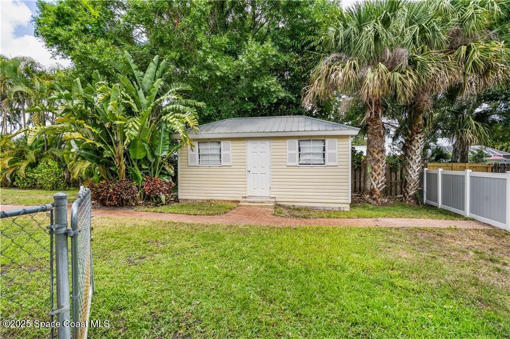 Undisclosed Address Vero Beach, FL 32966 - Photo 34 of 36 a backyard of a house with plants and large tree
