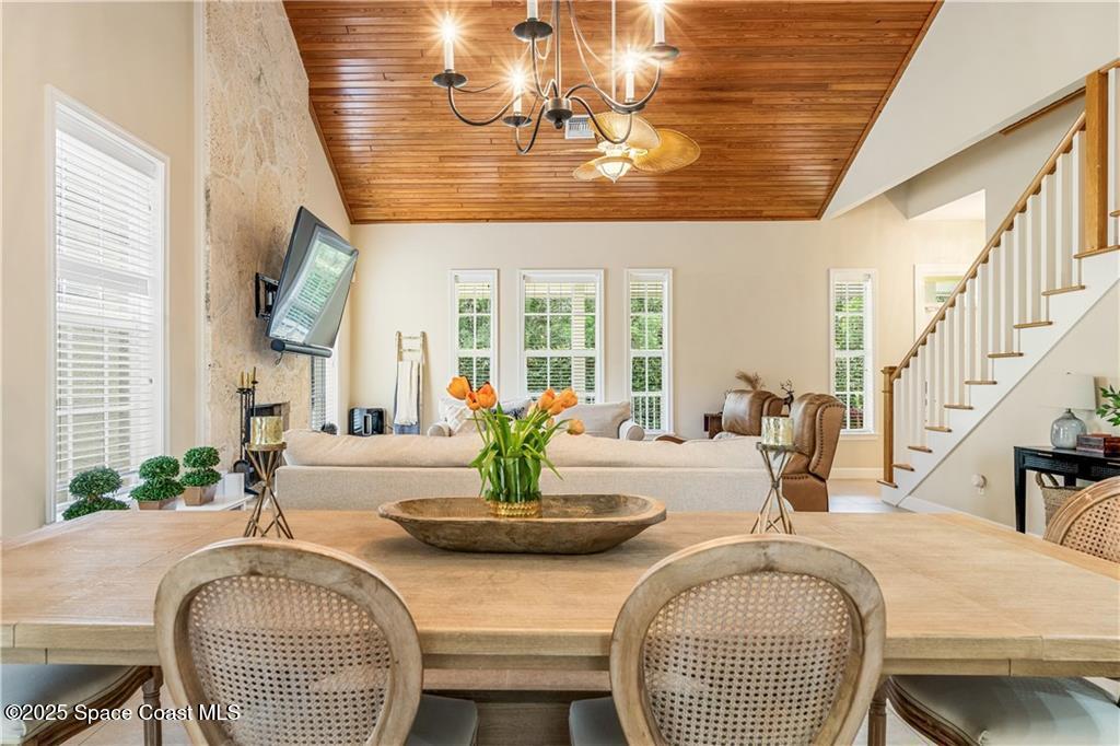 Undisclosed Address Vero Beach, FL 32966 - Photo 4 of 36 a dining room with wooden floor a chandelier a glass table and chairs