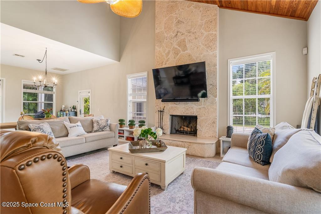 Undisclosed Address Vero Beach, FL 32966 - Photo 10 of 36 a living room with furniture a fireplace and a flat screen tv