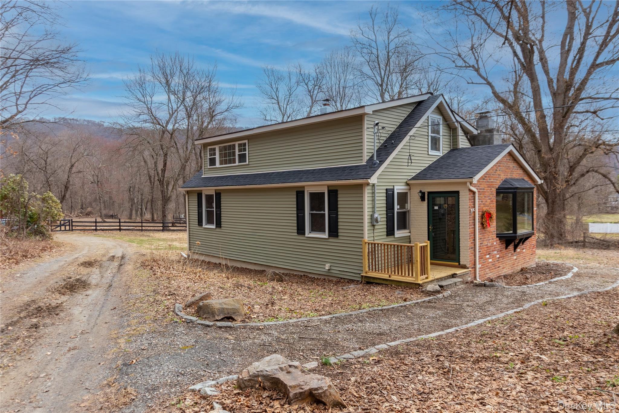 a front view of a house with yard and trees