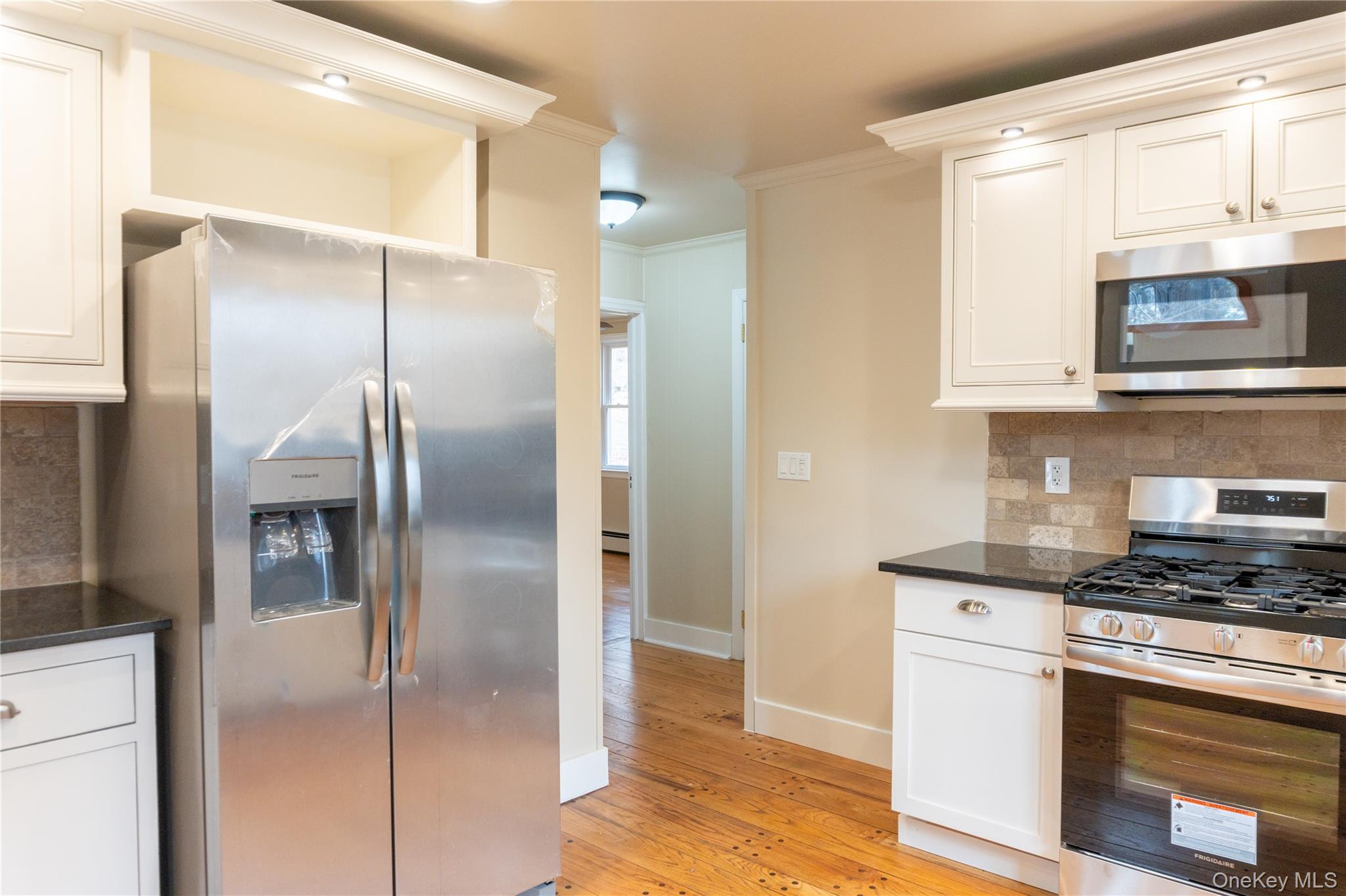 523 Shenandoah Road Hopewell Junction, NY 12533 - Photo 4 of 27 a kitchen with stainless steel appliances granite countertop a refrigerator a stove and a microwave