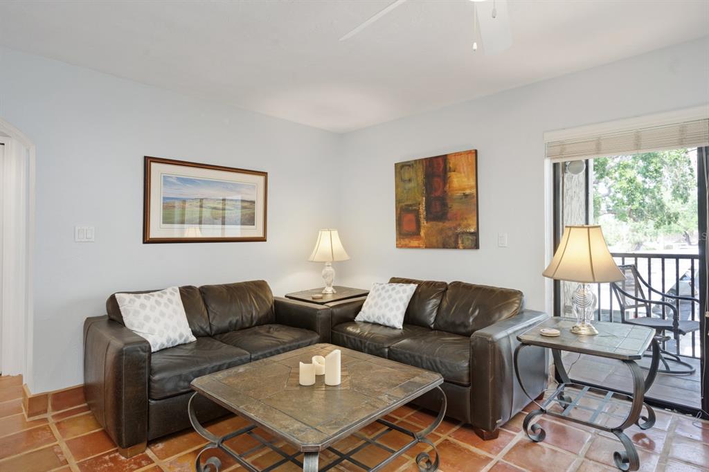 6157 Midnight Pass Road, Unit E22 Sarasota, FL 34242 - Photo 12 of 48 a living room with furniture and a two large window