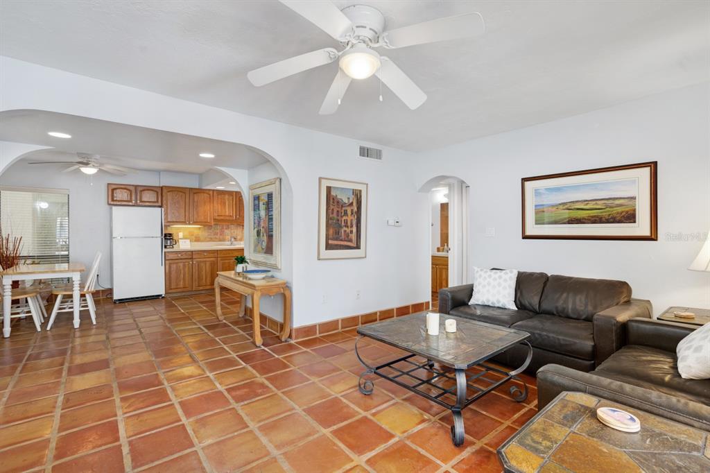 6157 Midnight Pass Road, Unit E22 Sarasota, FL 34242 - Photo 14 of 48 a living room with furniture a dining table and a dining table with wooden floor