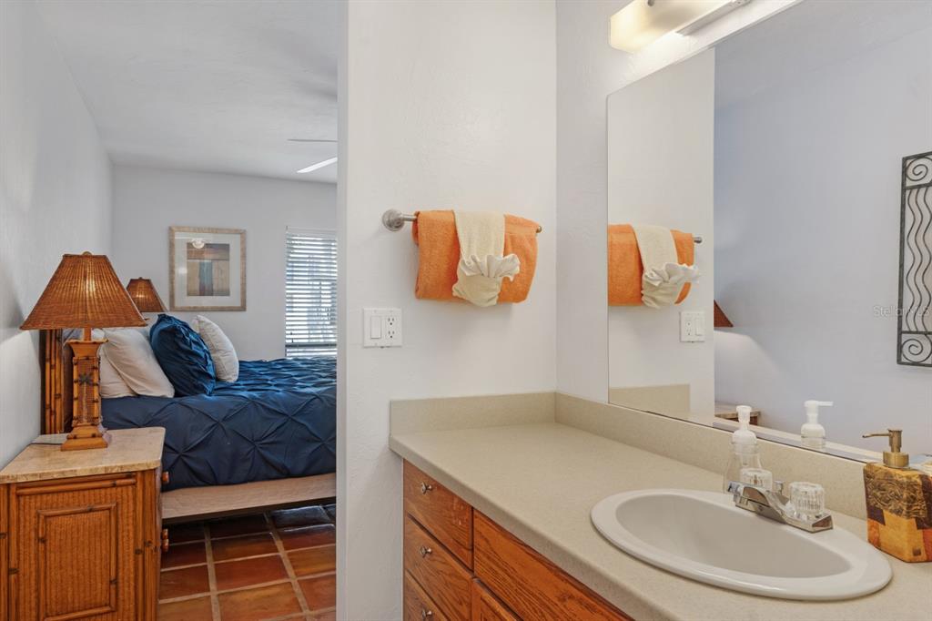 6157 Midnight Pass Road, Unit E22 Sarasota, FL 34242 - Photo 19 of 48 a bathroom with a sink and a mirror