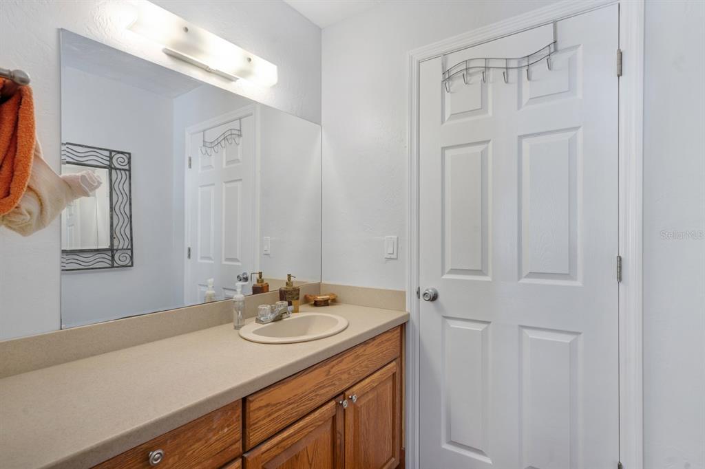 6157 Midnight Pass Road, Unit E22 Sarasota, FL 34242 - Photo 20 of 48 a bathroom with a sink vanity and a mirror