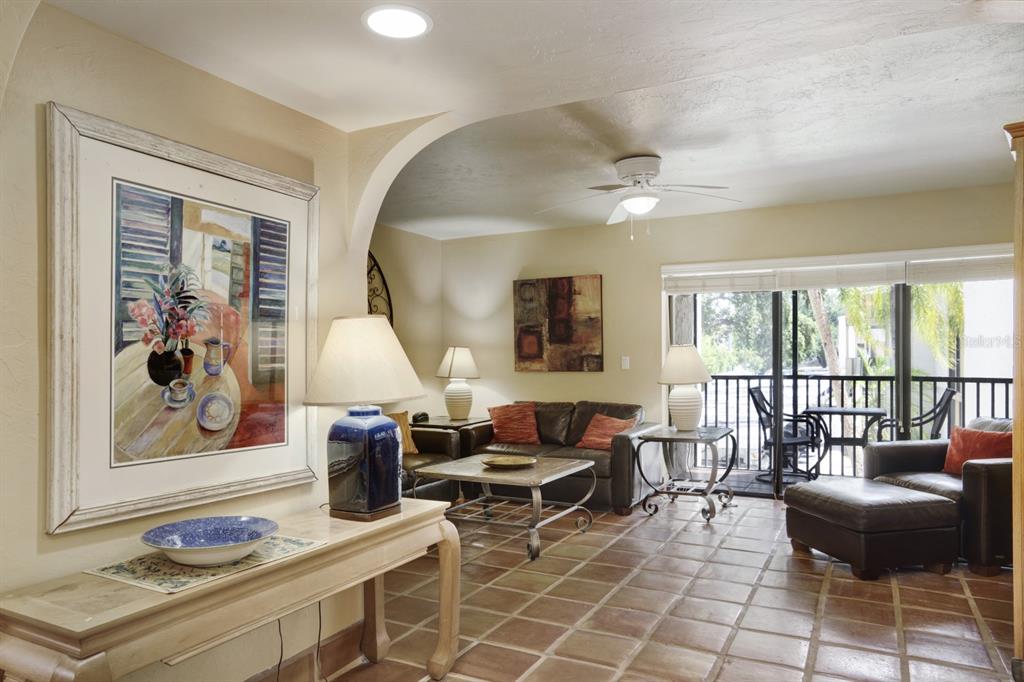6157 Midnight Pass Road, Unit E22 Sarasota, FL 34242 - Photo 29 of 48 a living room with furniture and a large window