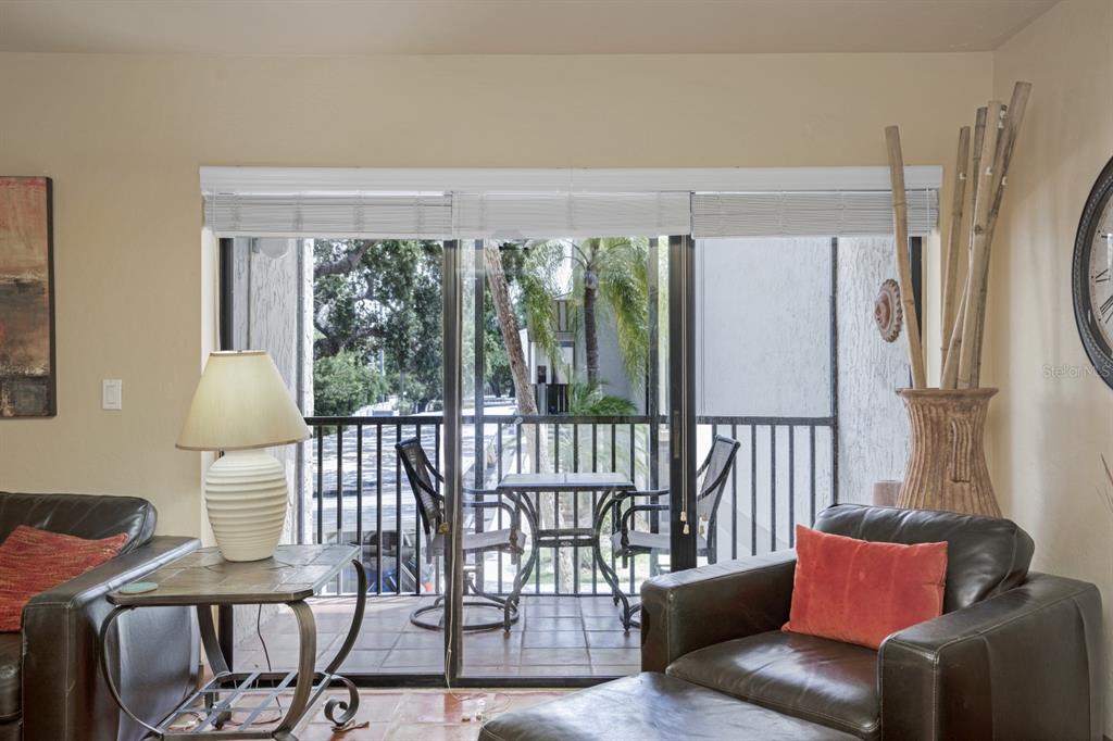 6157 Midnight Pass Road, Unit E22 Sarasota, FL 34242 - Photo 30 of 48 a living room with furniture and a window