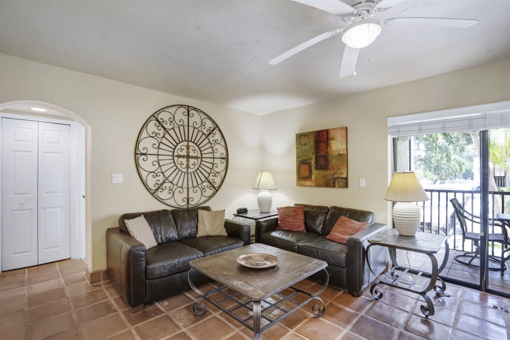 6157 Midnight Pass Road, Unit E22 Sarasota, FL 34242 - Photo 31 of 48 a living room with furniture a table and a large window