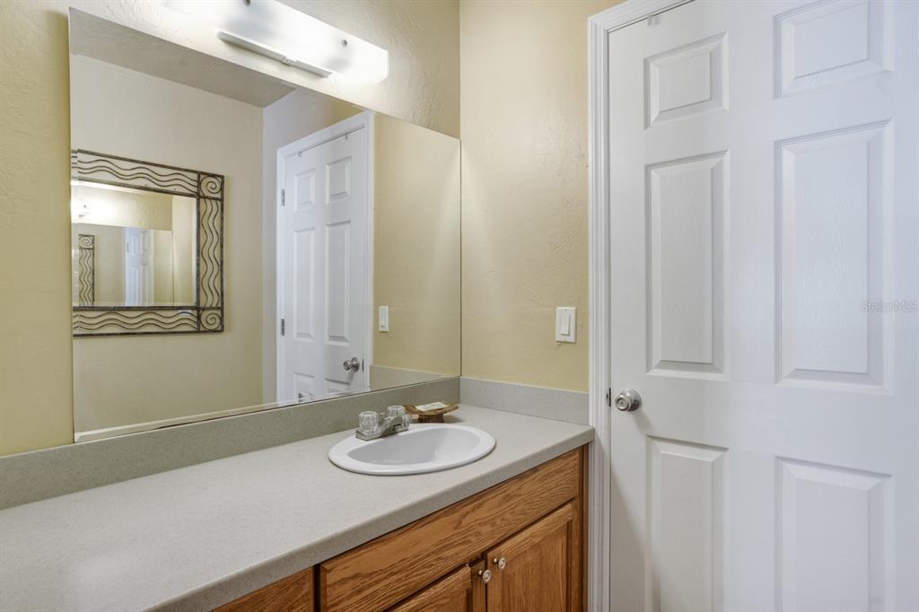 6157 Midnight Pass Road, Unit E22 Sarasota, FL 34242 - Photo 38 of 48 a bathroom with a sink and a mirror