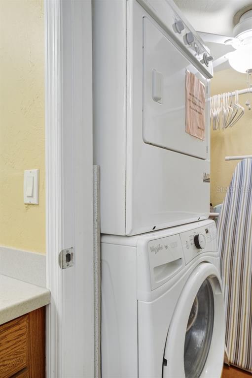 6157 Midnight Pass Road, Unit E22 Sarasota, FL 34242 - Photo 39 of 48 a utility room with dryer and washer