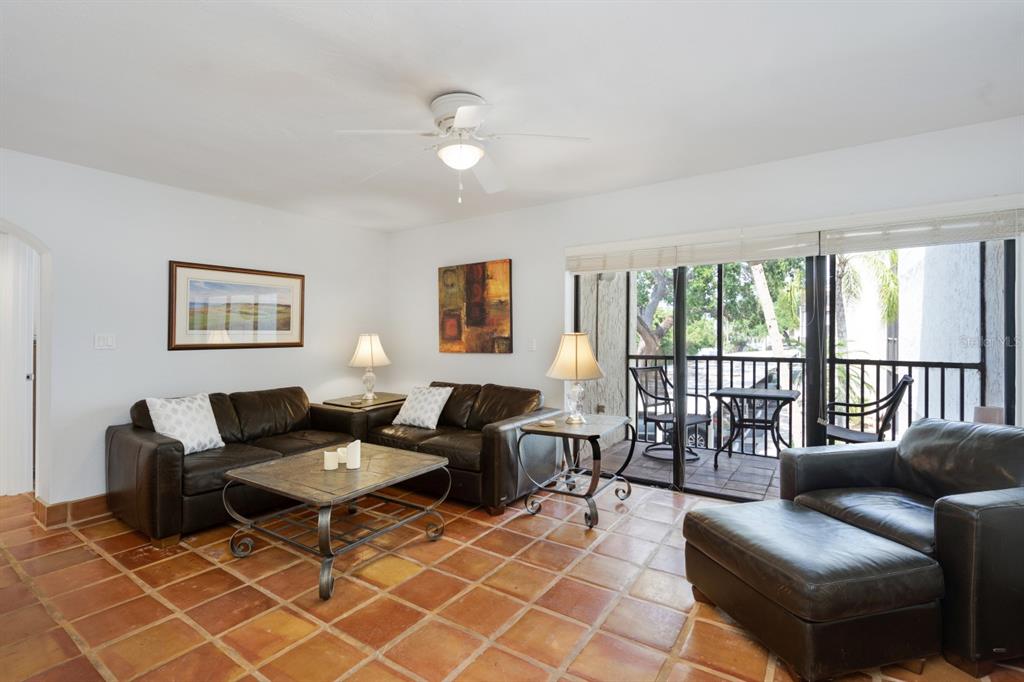 6157 Midnight Pass Road, Unit E22 Sarasota, FL 34242 - Photo 9 of 48 a living room with furniture and a large window