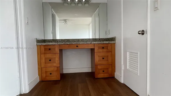 a living room with a dresser and a mirror