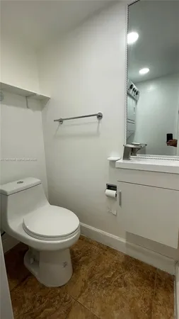 a bathroom with a sink toilet and vanity
