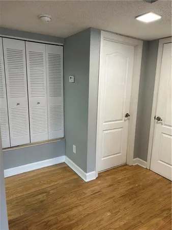 a view of empty room with wooden floor