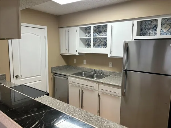 a kitchen with a refrigerator and a stove