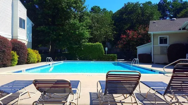 a backyard of a house with barbeque oven table and chairs