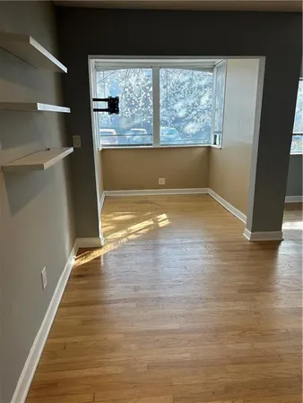 a view of a room with wooden floor and window