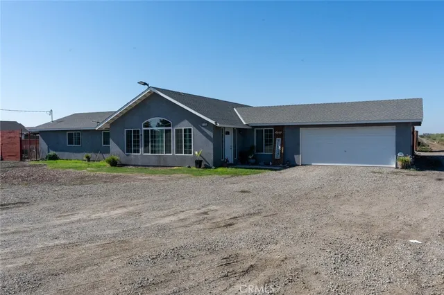 a backyard of a house with yard and outdoor seating