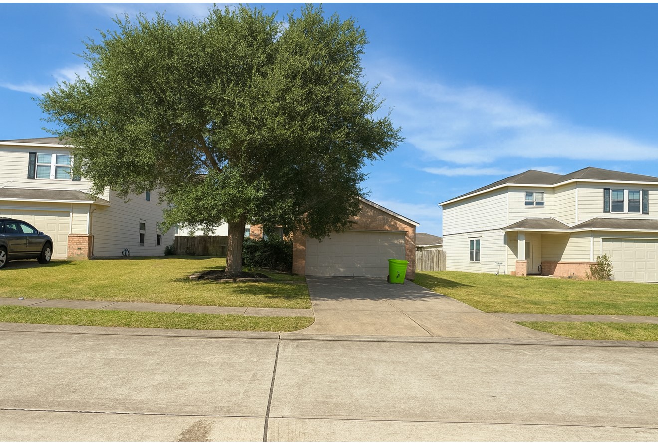 1130 Desert Springs Lane Rosenberg, TX 77471 - Photo 2 of 7 a view of a house with a yard and large trees