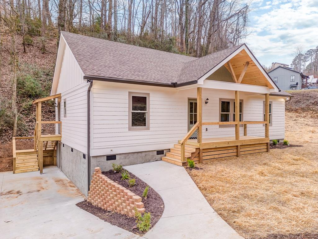 a view of house with a yard and wooden fence