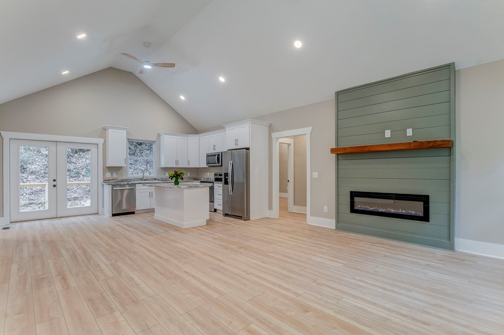 79 Logan Lane Ellijay, GA 30540 - Photo 18 of 56 a room with stainless steel appliances kitchen island granite countertop a stove and a refrigerator