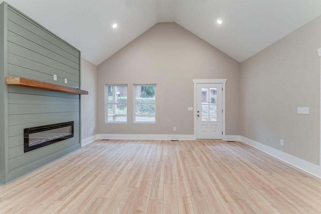 79 Logan Lane Ellijay, GA 30540 - Photo 24 of 56 an empty room with windows and fireplace