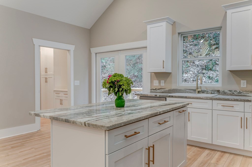 79 Logan Lane Ellijay, GA 30540 - Photo 26 of 56 a kitchen with granite countertop stainless steel appliances sink and wooden floor